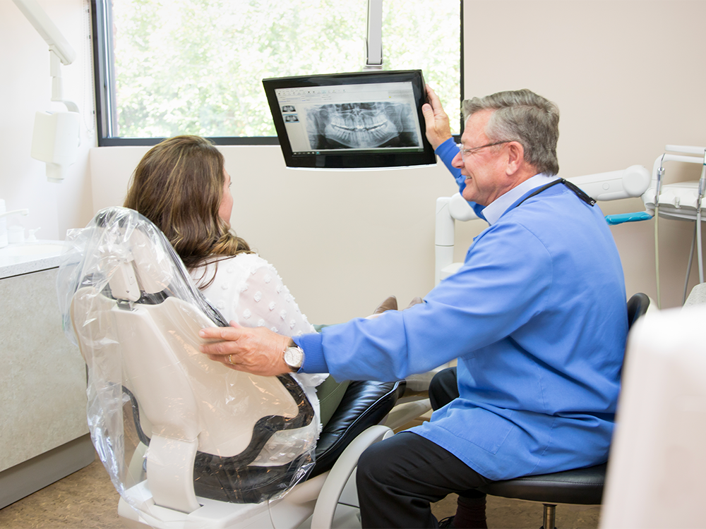 Dr. Stuart showing the patient X-rays.